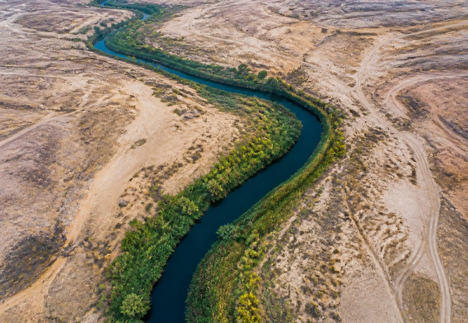 Aerial view of a river cutting through arid terrain